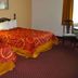 Avalon Inn in Sandusky guest room with two beds and a bedside lamp