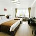 Hotel Hu Incheon Airport room with two beds, desk, TV and window seating in Incheon