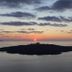 Theoxenia Caldera Hotel, Thera: sunset over sea and volcanic islands with calm caldera views