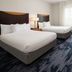 Fairfield Inn & Suites by Marriott Santa Maria guest room with two beds, desk and TV