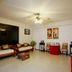 Bamboo Beach Hotel & Spa in Patong lobby with wooden seating, ceiling fan and red table