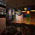 Luna Boutique Hotel, Antalya bar area with colorful stained-glass wall and long table