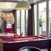 Hôtel Mercure Marne-la-Vallée Bussy-Saint-Georges lounge with pool table, red chairs and large windows