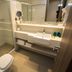 Petit Rio Hotel in Rio de Janeiro bathroom with glass shower, toilet, and vanity sink