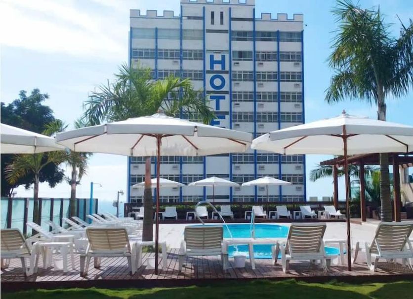 Rede Andrade Atlântico in Piçarras with outdoor pool, lounge chairs and oceanfront view