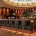 Mediterranean Palace hotel bar in Thessaloniki with circular stained-glass ceiling and high stools