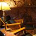 Lodge At Sedona lounge with stone fireplace, wooden chairs, and warm lamp lighting