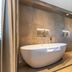 Parkhotel Horst bathroom with freestanding soaking tub and walk-in shower in Horst
