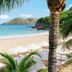 Cheval Blanc St-Barth beach with white umbrellas, palm trees and turquoise ocean in Gustavia