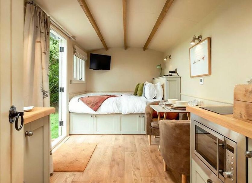 Great Ashley Farm in Bradford-on-Avon, cozy guest room with twin bed, wood floors, and open garden door
