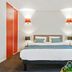 Appart'City Confort Lille Grand Palais bedroom in Lille with double bed and wood wardrobe