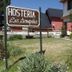 Hosteria Las Amapolas in San Carlos de Bariloche with sign, garden, and stone path outside