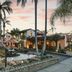 Brisas Del Mar Inn at the Beach in Santa Barbara, palm-lined courtyard with sunset-lit hotel exterior