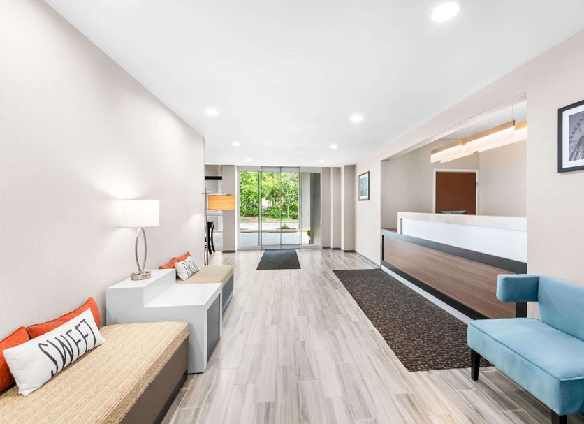 Sleep Inn and Suites Pigeon Forge - Downtown lobby with front desk, seating area, and bright entryway