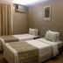 Plaza Bittar Hotel in Brasilia twin room with two beds, window air conditioner, and desk