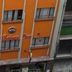 Hotel Bolivar Plaza in Manizales, orange facade with guest room windows and signage