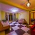 Hotel Royal Nest Entebbe lobby with checkered tile floor, seating area and glass entry doors
