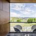 Exe Las Margas Golf Hotel in Latas balcony with two chairs, table and mountain golf course view