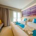 Bizotel Premier Hotel & Residence in Bangkok twin room with swan towels, blue bedding and wall art