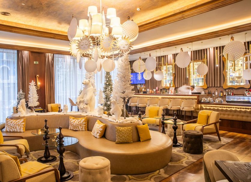 Vip Executive Picoas Hotel lounge in Lisbon with gold seating, chandelier, and stylish bar area