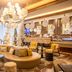 Vip Executive Picoas Hotel lounge in Lisbon with gold seating, chandelier, and stylish bar area