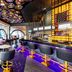 Planet Hollywood Cancun, An Autograph Collection Resort bar with neon-lit stools and geometric ceiling