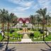 Swisstouch Oriental Resort in Al Quşayr with palm-lined entrance and landscaped roundabout