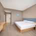 Homeinn Hotel (Anshun Ancient City Gufu Street) guest room with bed, desk and wall-mounted TV in Anshun