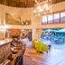 Ivory Tree Game Lodge in Pilanesberg lounge and bar with curved counter, fireplace, and pool terrace view