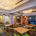 Fairfield Inn & Suites by Marriott Orange Beach breakfast seating area with tables and TV