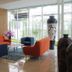 Grand Orchid Hotel Yogyakarta lobby seating area with orange and blue chairs by large windows