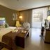Hotel Livvo Valle Taurito & Aquapark room in Mogán with king bed, balcony light, and seating area
