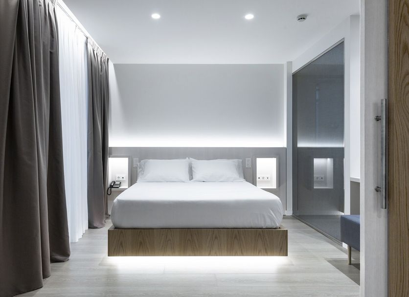 Hotel Indalo Park in Santa Susanna: modern guest room with king bed, soft lighting, and floor-to-ceiling curtains