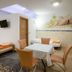 Penzion Kovac in Radovljica guest room with twin beds, table, chairs and skylight