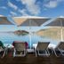 Tymnos Hotel in Bozburun with sun loungers and umbrellas overlooking a calm sea and small island