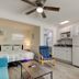 Carousel Suites -Redington Shores guest room with bed, kitchenette, sitting area and ceiling fan