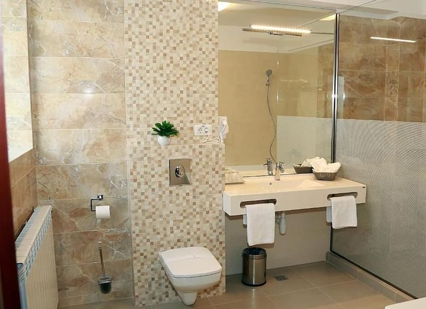 Parliament Square Bucharest bathroom with glass shower, wall-hung toilet and vanity sink
