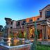 Velmore Hotel & Spa in Pretoria with a courtyard fountain and columned entrance at dusk