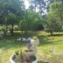 Hotel La Costera in A Lanzada with a landscaped garden, palm trees, and lawn seating area