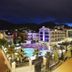 Ideal Pearl Hotel Adults Only in Marmaris with illuminated pool, palm trees, and mountain backdrop at night