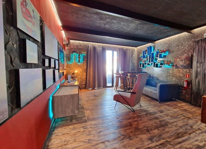 Ocean Suites Santa Maria lounge with modern seating, neon wall art and colorful decor