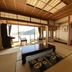 Atami Onsen Guest House Megumi in Atami, tatami room with low table and ocean-view seating