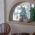 Hotel Arenas del Pacifico in La Crucecita with arched interior window and wicker chairs
