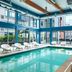 Aloft Seattle Redmond indoor pool with floor-to-ceiling windows and lounge chairs in Redmond