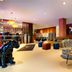 Nyx Hotel Mannheim by Leonardo Hotels lobby with zebra chairs, colorful seating and black panther sculpture in Mannheim