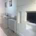 Self Contained Rooms in Central Torquay: compact kitchenette and wall-mounted TV in a bright room
