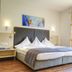 Hotel Jakob, Groß-Umstadt: bright guest room with double bed and balcony doors to greenery