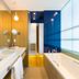 D-Resort Sibenik Šibenik bathroom with double sink, bathtub, and blue-tinted window wall