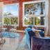 Rendezvous Mendocino in Gualala guest room with large windows, blue bedspread, and seating area