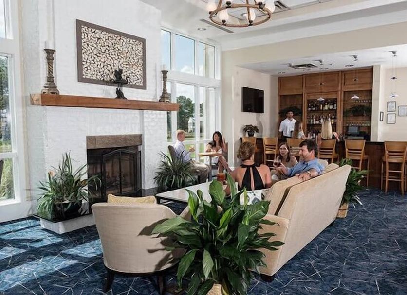 Lake Blackshear Resort & Golf Club lobby lounge in Cordele with fireplace, bar, and seating area